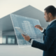 Architect reviewing digital architectural compliance management tools on a large screen, with building plans, representing smart and risk-free project management.