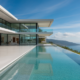 Modern luxury mansion with ocean views, representing high-value real estate auctions