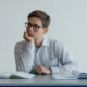 High school student contemplating two academic test options, representing the choice between SAT and ACT.