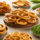 Assortment of healthy, traditional Telugu snacks like banana chips and chakodi, on a clean background.