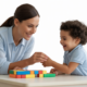 Professional photograph depicting a child and an RBT engaging in supportive behavioral therapy, illustrating growth and development for children in Muscatine.