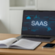 Professional lawyer's desk with a laptop displaying SaaS data and legal documents, symbolizing a SaaS agreement lawyer's expertise.
