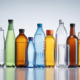 Array of diverse PET bottles in various shapes and colors on a white background representing PET bottle manufacturing and packaging