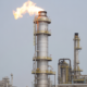 Photorealistic image of a modern flare system with active flame at a petrochemical refinery, clean background, professional lighting
